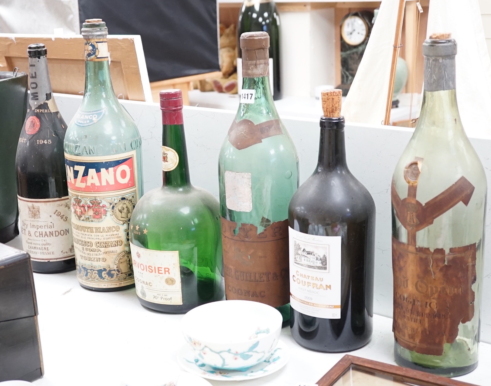 A collection of oversize and advertising bottles for Cinzano, Courvoisier, Moet Chandon, Rouyer Guillet cognac, Grand Opera cognac and Chateau Coufran, largest 52 cm